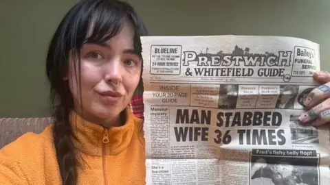Gemma Ahern Gemma holding Prestwich & Whitefield Guide old newspaper with headline Man stabbed wife 36 times
