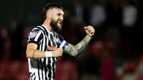 Kyle Cameron celebrates while playing for Notts County