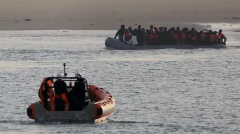 Reuters File photo of a French rescue vessel with a group of migrants on an inflatable dingy