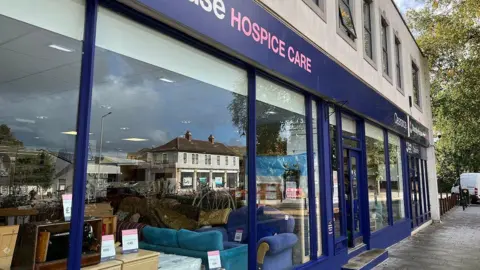 Front of a Dorothy House furniture shop along a street in Trowbridge, Wiltshire. Sofas and bedside tables can be seen inside of it.