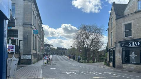 A picture of a main street leading over a bridge in Bradford-on-Avon. 