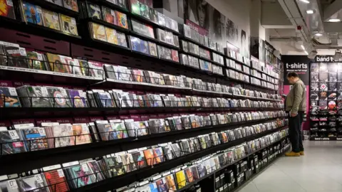 Getty Images A man browses CDs inside the original branch of the HMV chain of music retailers on December 28, 2018 in London