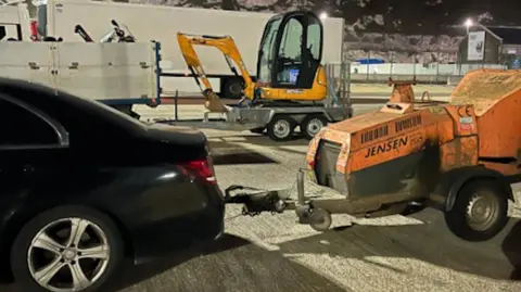 Kent Police Farming vehicles at a port at night. 