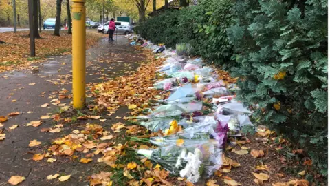 Flowers outside house where Leah Croucher's remains were found in Milton Keynes