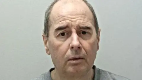 Lancashire Police photo of Alan Murphy with balding hair and a grey jumper 