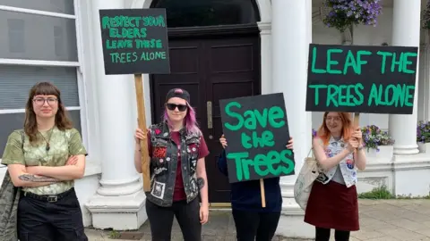 BBC Protestors holding placards