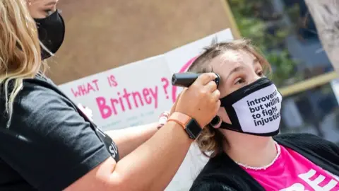 Woman getting her head shaved