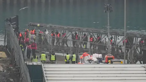 PA Media A group of people thought to be migrants are brought in to Dover, Kent, from a Border Force vessel following a small boat incident in the Channel. 