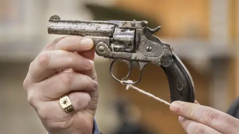 Liam McBurney/PA Media A revolver owned by Collins sold for £9.000