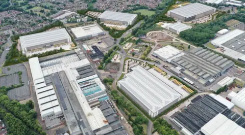 bhp design A mocked up aerial view of industrial units interspersed with landscaping, access roads and car parking.