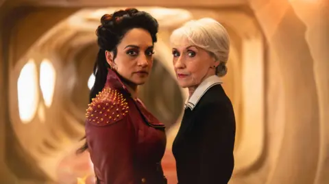 Archie Panjabi and Anita Dobson stood together in costume both playing the Rani