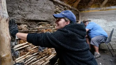 PA Media Bronze age roundhouse at Butser Ancient Farm