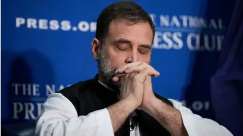 Getty Images Indian opposition leader Rahul Gandhi pauses while listening to a question at the National Press Club on June 1, 2023 in Washington, DC.