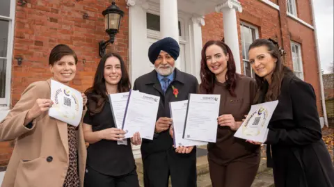 City of Wolverhampton Council From left, Emma Caddick, service manager – environmental health at City of Wolverhampton Council, Ophelia Margiasso, owner of OB Brows, councillor Bhupinder Gakhal, cabinet member for resident services, Hayley Williams, owner Haylo Skincare and Charlotte Rose, team leader – environmental health at the council.