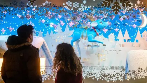 Getty Images A couple look in a Christmas window