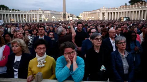 Reuters A crowd stands in rows that stretch back into St Peter's Square