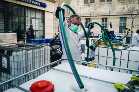 Getty Images A pharmacy in Paris's Latin Quarter has started making sanitiser in the street