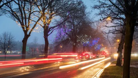 Alamy cars at dusk with christmas lights