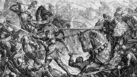 Getty Images A detailed black-and-white engraving shows a chaotic medieval battle with armored soldiers clashing using swords, shields, and lances.

Mounted knights on horses charge into combat while foot soldiers struggle in close quarters.

The scene is densely packed with movement, emphasizing the intensity and violence of the battlefield.