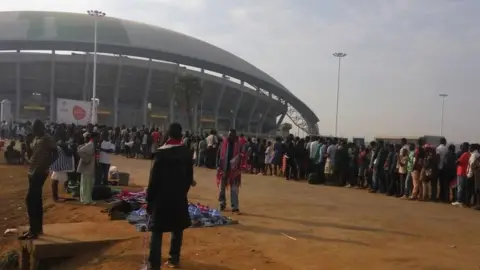 BBC people queue to get into the Bingu stadium