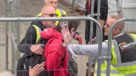 The protester was removed from the area by builders Paul Stott and Mick Wright following the incident 