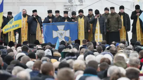 Reuters Ukrainians gather outside Saint Sophia's Cathedral in Kiev