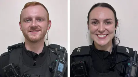 Two side-by-side images of PC Daniel Secker and PC Hannah Nutter in their black uniforms. Both are smiling. Secker has red hair and a short beard and Nutter has long dark hair tied back