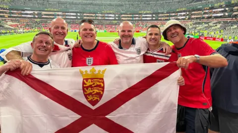 Paul Wilson Jersey football fans hold the Jersey flag at the Azteca Stadium in Mexico after England’s World Cup win. 