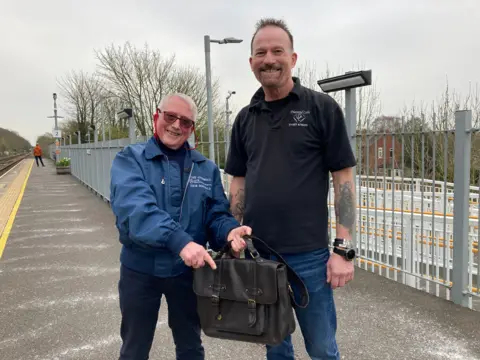 Tony Sherwood with his lost bag and taxi driver David Sanderson-Cole