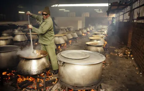 Getty Images Food is prepared by the Saaberie Chishty Society in a large kitchen in the Lenesia suburb of Johannesburg.