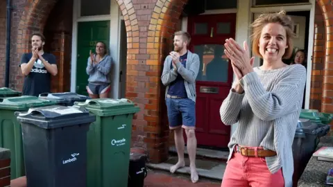 Getty Images Annemarie Plas and her neighbours clap for the NHS