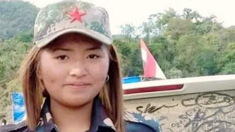 Family flyer Lalnunpuii, 17, in military fatigues