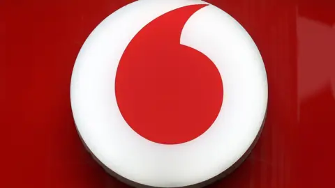 EPA Vodafone's red and white logo displayed in a close-up shot of a storefront's sign.