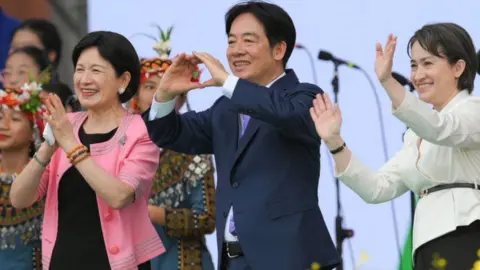 Getty Images Taiwan's President Lai Ching-te (C), incoming First Lady Wu Mei-ju (L) and Vice President Hsiao Bi-khim (R) react after his inaugural speech after being sworn into office during the inauguration ceremony at the Presidential Office Building in Taipei on May 20, 2024.