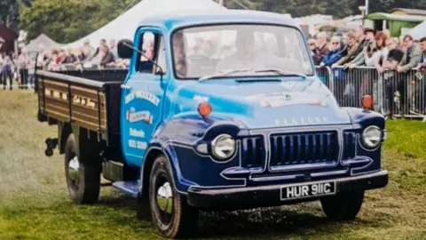The image shows Ben in one of his first pick-up trucks 