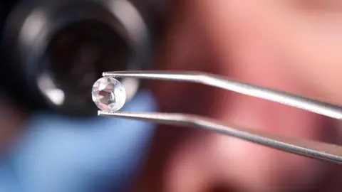 Getty Images A jeweller examines a diamond