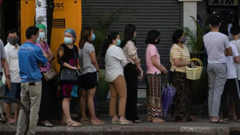 Reuters People line up outside a bank branch in Yangon, Myanmar, 1 February 2021.