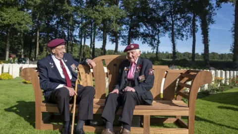 PA Media Veterans Geoff Roberts (left) and Ray Whitwell at the CWGC Oosterbeek War Cemetery near Arnhem, Netherlands on 20 September 2019