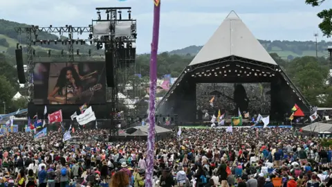 Getty Images View of the Pyrmid Stage and crowd with Olivia Dean on stage and on a big screen