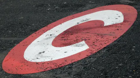 Large white Congestion Charge 'C' inside red box