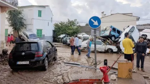 EPA Cars are piled up on top of each other in a muddy street