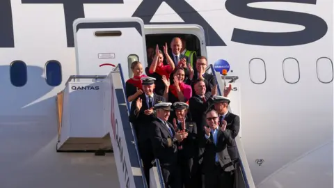 AFP/HANDOUT Qantas Group CEO Alan Joyce and crew after arriving at Sydney airport after completing a non-stop test flight from New York