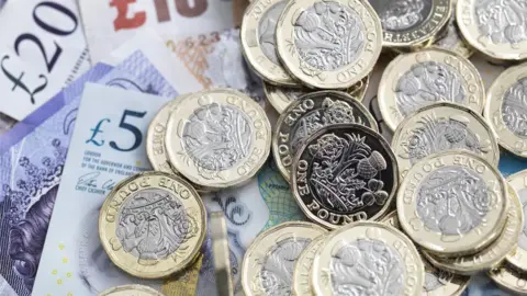 Getty Images Pound sterling notes and coins