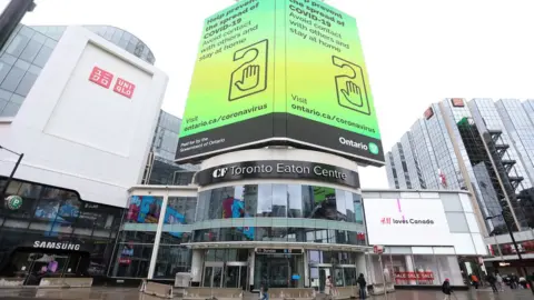 Toronto Star via Getty Images Toronto's Eaton Centre has concrete barriers in place at ground level entrances as only essential industries are open