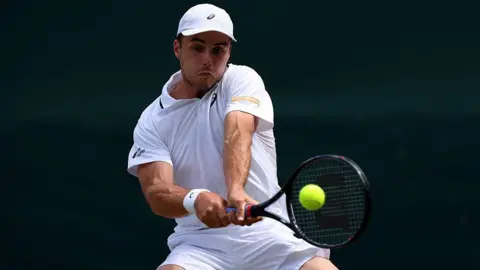 Getty Images Arthur Fery of Great Britain plays a backhand against Zizou Bergs of Belgium during their Gentlemen's Singles third round match on day six of The Championships Wimbledon 2026 at All England Lawn Tennis and Croquet Club on July 04, 2026 in London, England