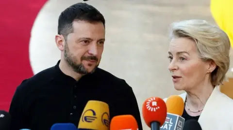 Volodymyr Zelensky and Ursula von der Leyen stood with microphones