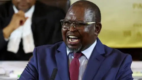 Reuters South Africa's Finance Minister Enoch Godongwana speaks during his 2024 budget speech in Cape Town, South Africa, February 21, 2024