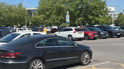 Several cars parked in a parking lot in Doncaster on a sunny day