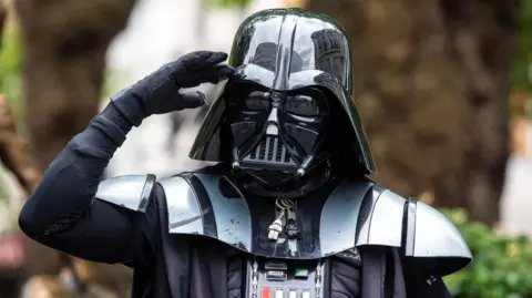 A person dressed as Star Wars character Darth Vader.