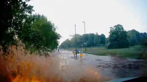 A flooded street in Derby after a burst pipe